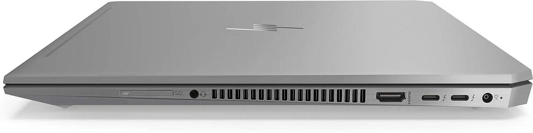 Silver laptop closed, showing side ports including USB, HDMI, SD card slot, and headphone jack.