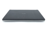 Closed Dell laptop with silver trim, viewed from the front on a white background