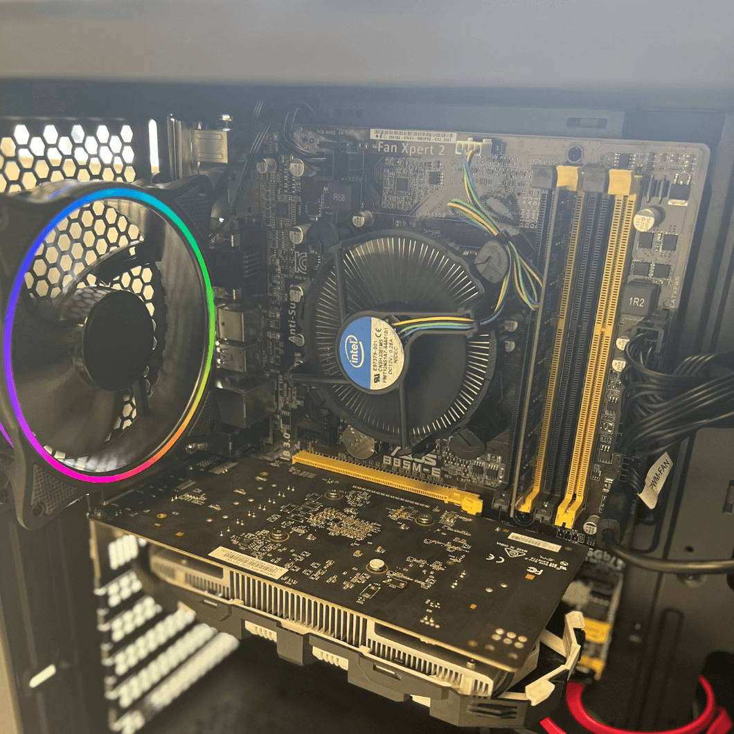 Close-up of desktop PC interior showing motherboard, Intel CPU cooler, RAM slots, GPU, and RGB fan.