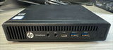 Refurbished HP EliteDesk mini desktop PC with front USB ports, headphone jack, and Intel Core i5 sticker on a desk