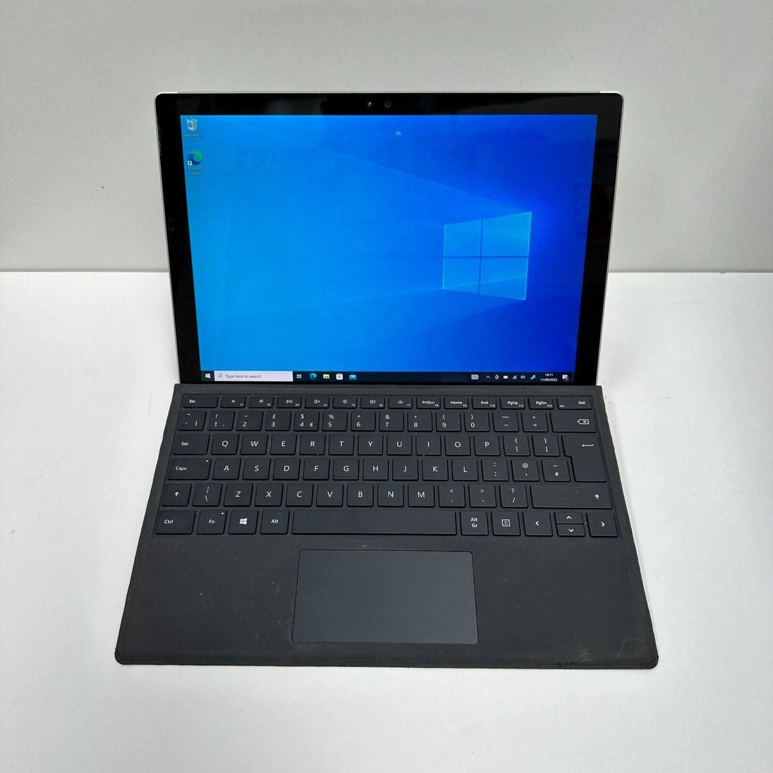 Refurbished Windows tablet with black keyboard and touchscreen on white background