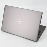 Silver HP laptop partially open on a white background, refurbished professional notebook