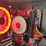 Close-up of desktop PC interior with red LED fan, motherboard, and RAM modules