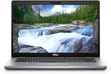 Dell laptop open with screen displaying a river landscape, silver keyboard visible