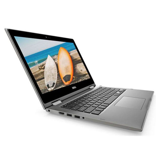 Dell silver laptop with open screen displaying surfboards by the beach