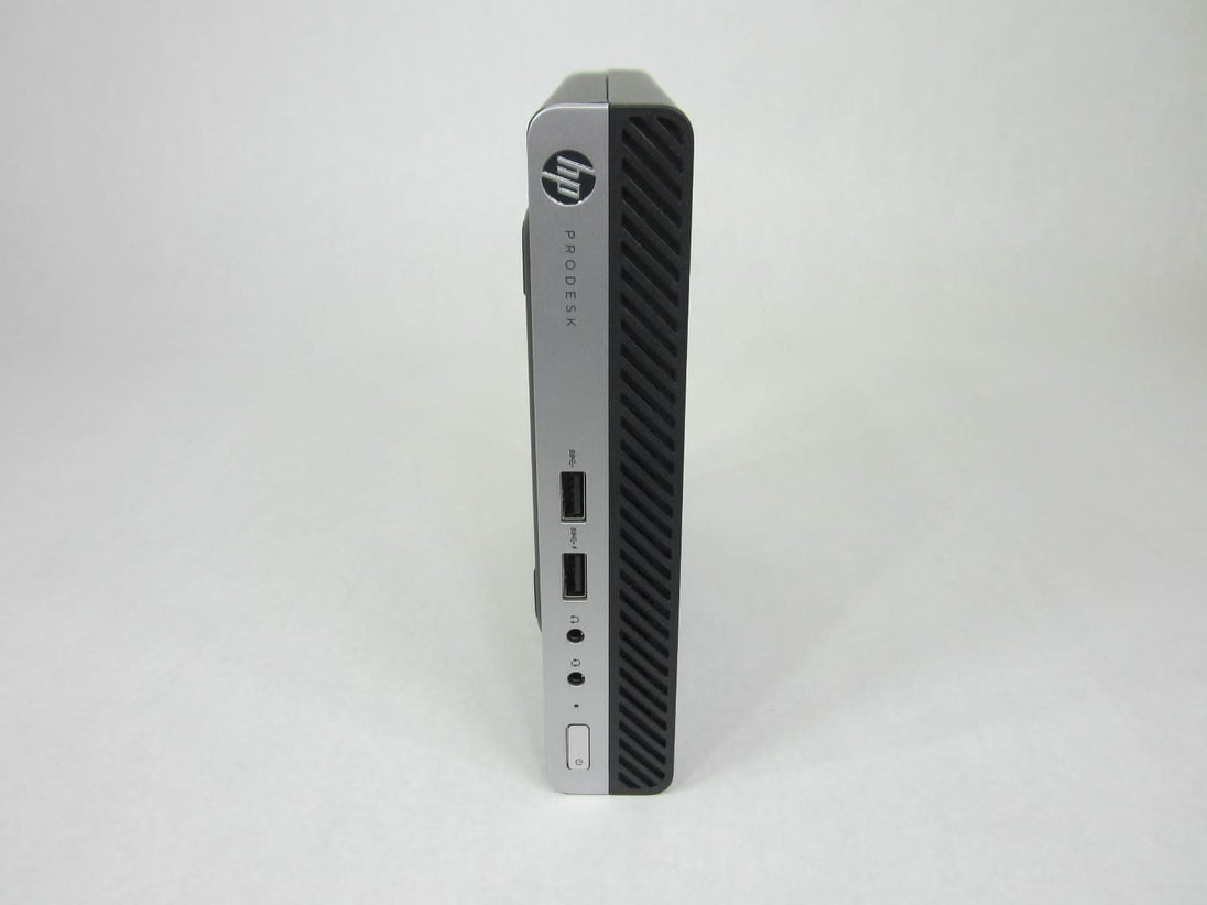 HP ProDesk mini desktop computer with front USB ports on a plain background