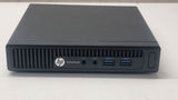 HP EliteDesk mini desktop computer with front USB and audio ports on white surface