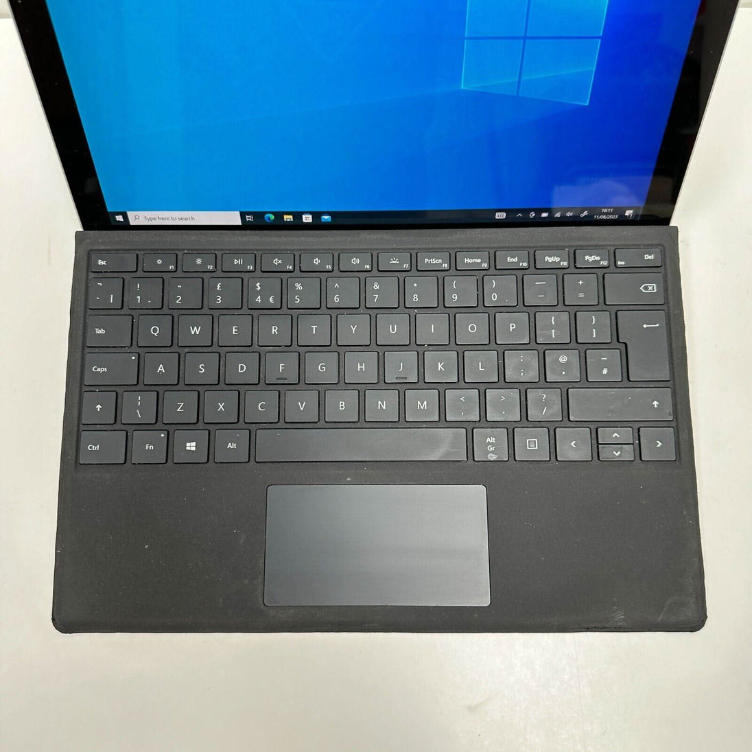 Refurbished Microsoft Surface tablet with black keyboard and Windows 10 home screen