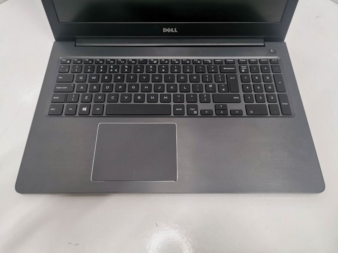Refurbished Dell laptop with full keyboard and numeric keypad on clean white surface
