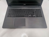 Refurbished Dell laptop with full keyboard and numeric keypad on clean white surface