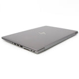 Closed silver business laptop with multiple side ports on a white background